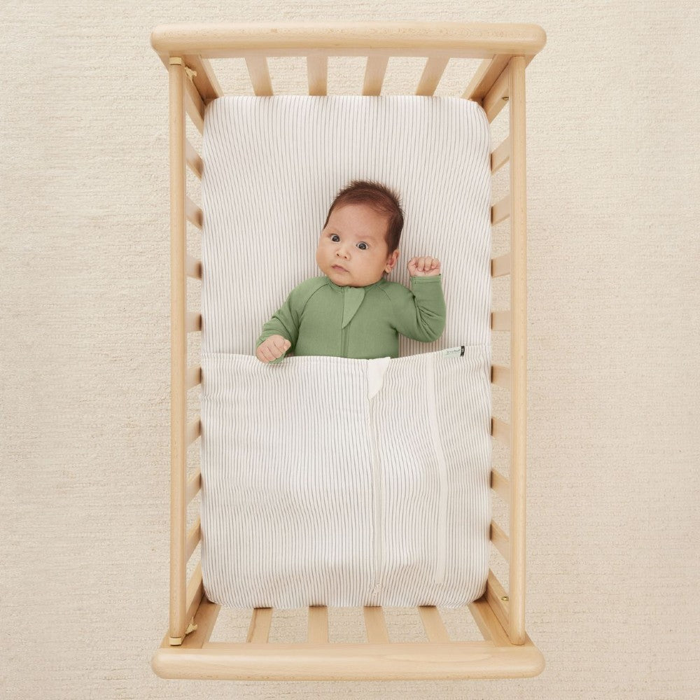 HugMe Blanket in Midnight Stripe pattern on a mattress on white background
