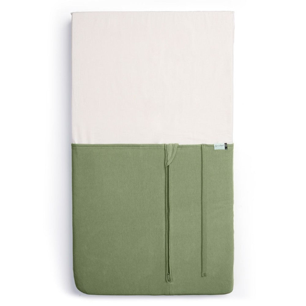HugMe Blanket in Moss pattern on a mattress on white background