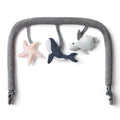 Gray baby bouncer with starfish, shark, and turtle toys on a white background