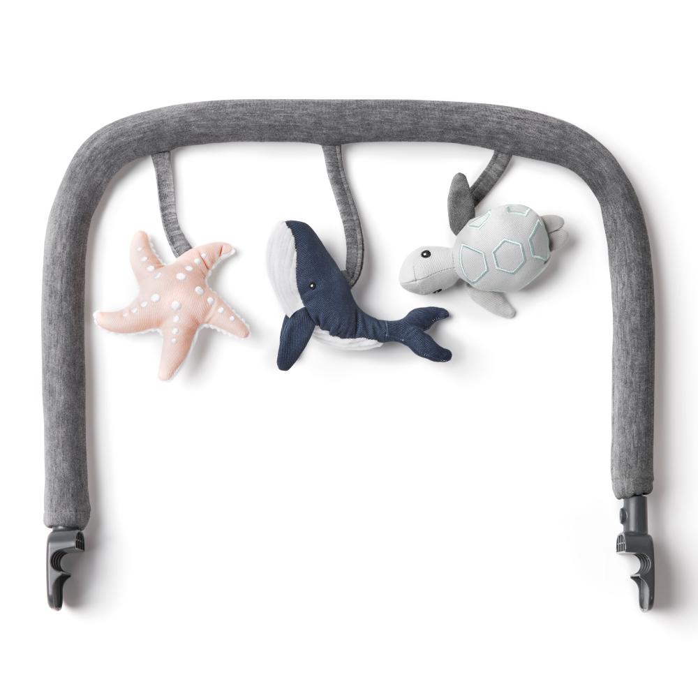 Gray baby bouncer with starfish, shark, and turtle toys on a white background