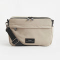 Beige Nappy Bag with Finnson label on a white background