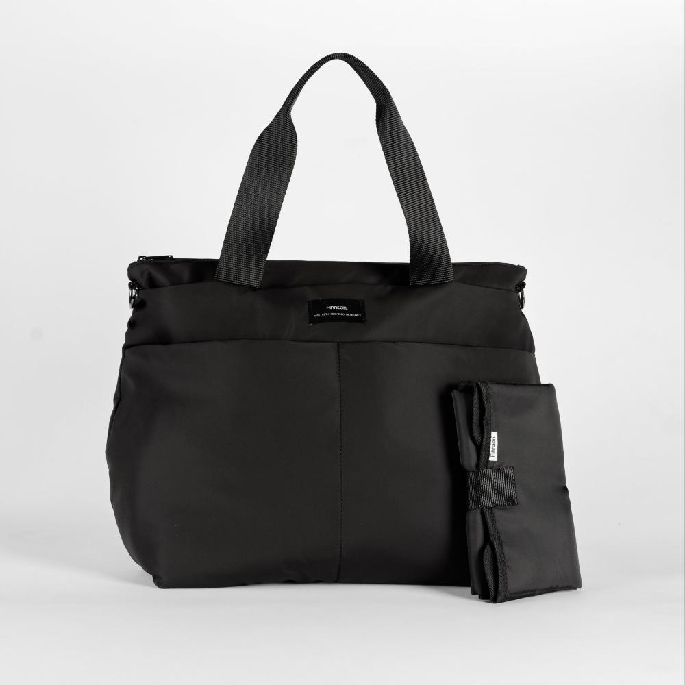 Black tote bag with a smaller black change mat on a light gray background