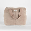 Beige sherpa nappy tote bag with brown handles on a white background