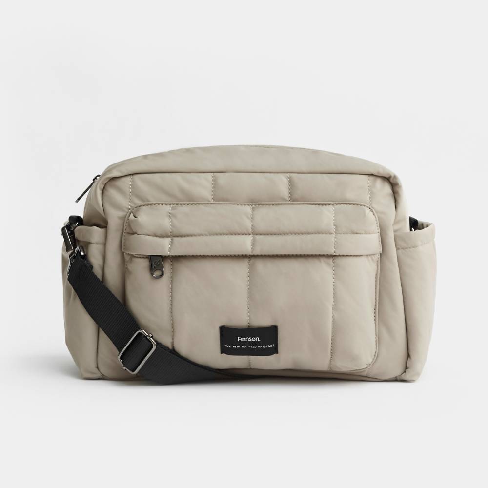 Beige Nappy Bag with Finnson label on a white background