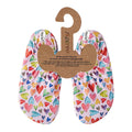 Colorful heart-patterned baby slipfree water shoes on a cardboard hanger with slipfree branding 