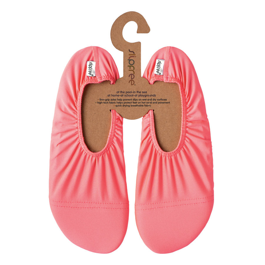 Pair of pink slip-on shoes on a hanger with 'slipfree' branding.