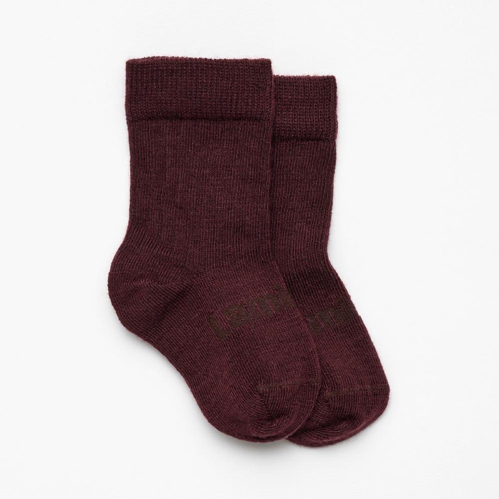 Maroon merino crew socks on a white background