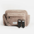 Beige fluffy Nappy Bag with Finnson label on a white background