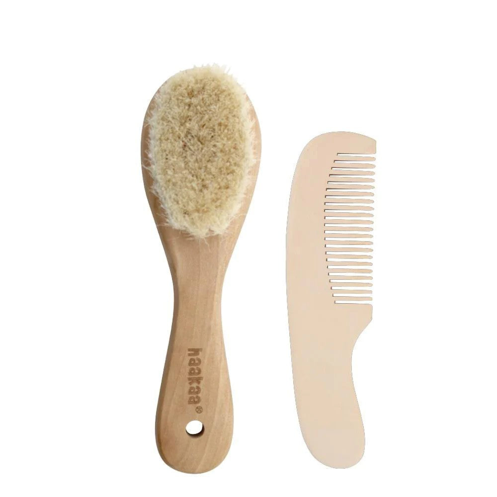 Haakaa rubberwood and goats wool brush with maplewood comb against a white background