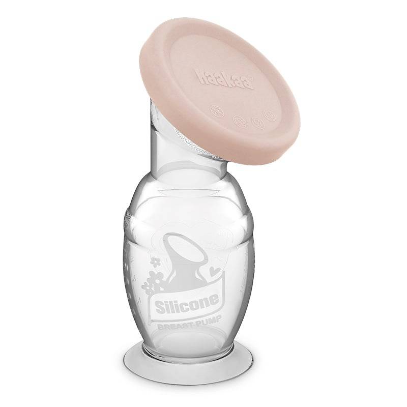 haakaa silicone manual breastpump with pink cap on a white background