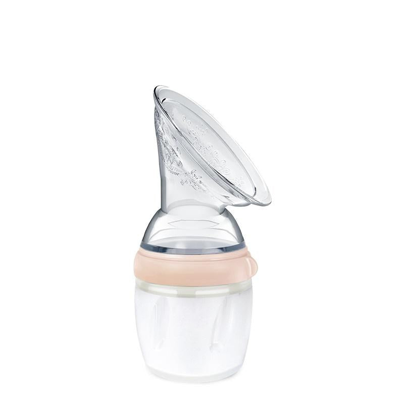Haakaa silicone manual breastpump with peach coloured ring on a white background 