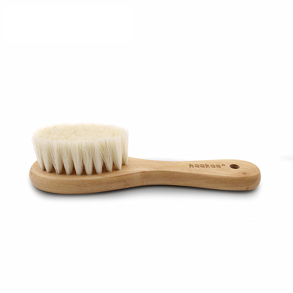 Rubberwood and goats wool baby hairbrush against a white background