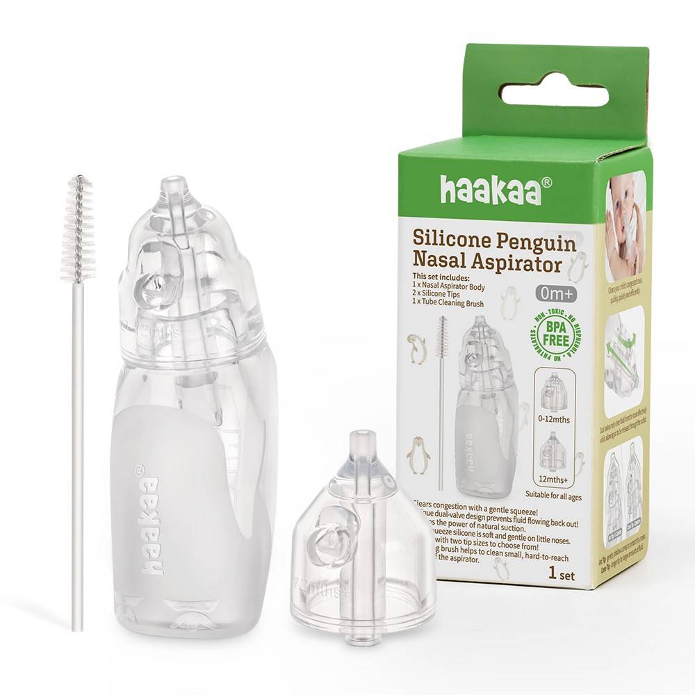 silicone penguin nasal aspirator with green packaging and cleaning brush on white background