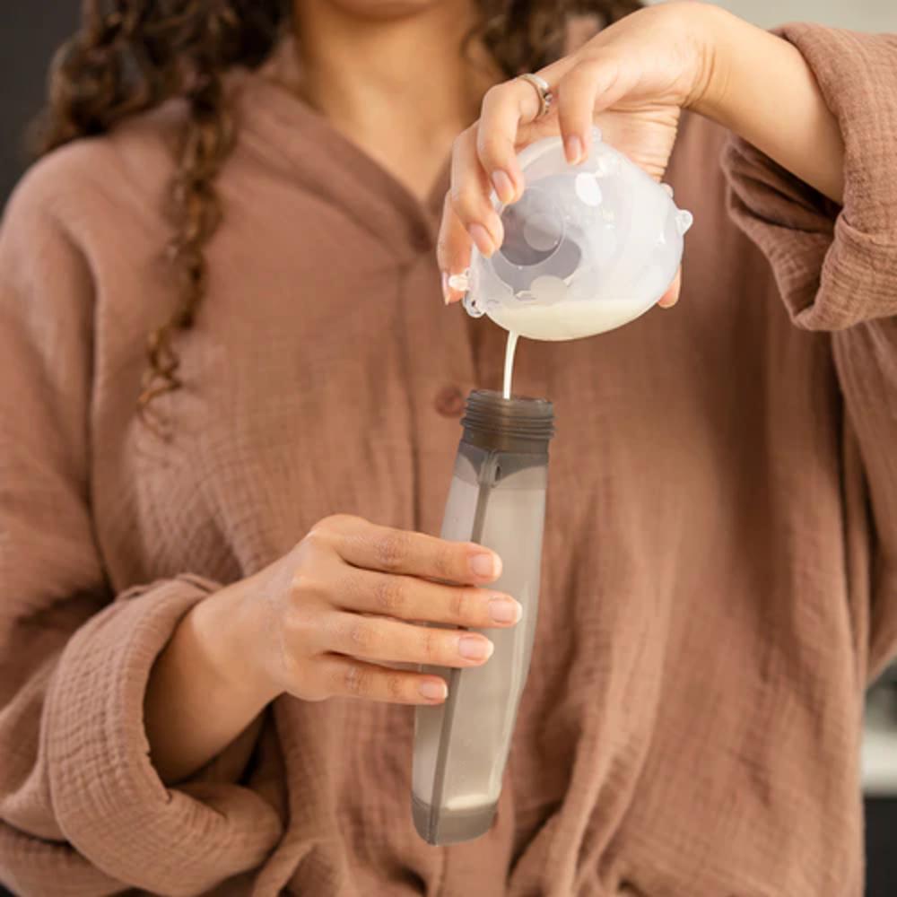 woman pouring milk from ladybug collector into re-usable storage pouch