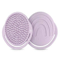 Lilac coloured silicone shampoo brush with soft bristles on a white background 