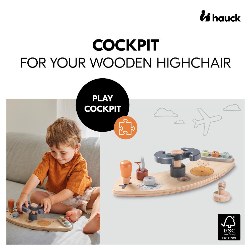 Wooden highchair cockpit toy with child playing, featuring the Hauck brand.
