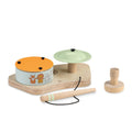 Wooden toy drum set with colorful components on a white background