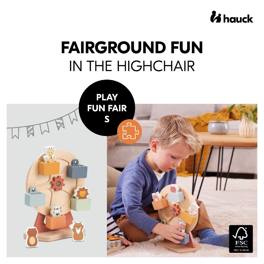 Child playing with a wooden toy in a highchair setting, with 'hauck' branding.