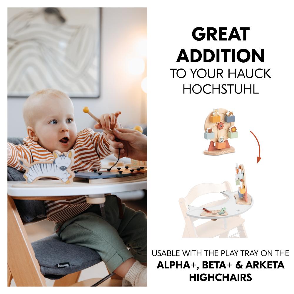 Child in a highchair with a toy and text about a product addition for Hauck highchairs.