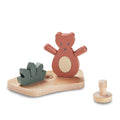 Wooden toy set with a bear figure and geometric shapes on a white background