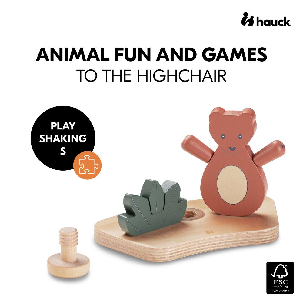 Wooden toy set with a bear figure and green piece on a white background, featuring the Hauck brand.
