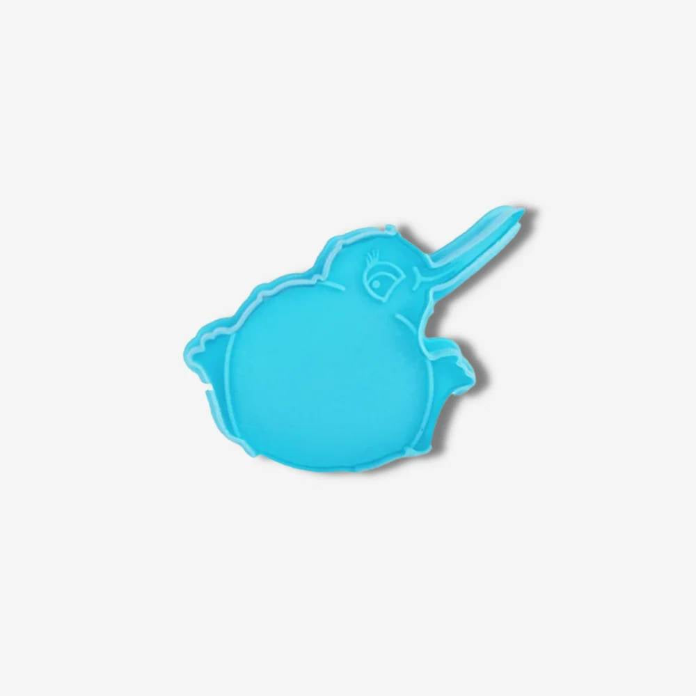 A blue kiwi shaped cookie cutter on white background.