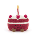 Red Jellycat cake soft toy against white background.