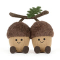 Brown Jellycat acorn soft toys with green leaf against white background. 