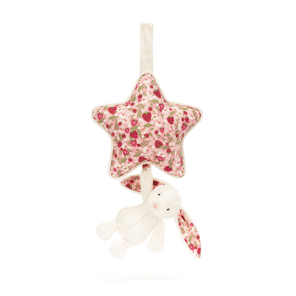 Jellycat star musical pull with pink strawberry print and small white bunny attached on white background.