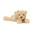 Small beige Jellycat bear soft toy laying against white background.