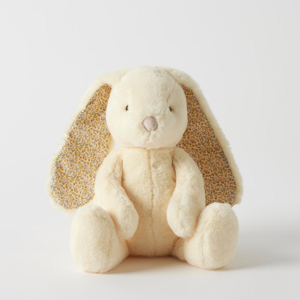 Yellow Plush toy rabbit with floral ears on a white background