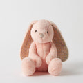 Pink plush bunny with floral ears on a white background
