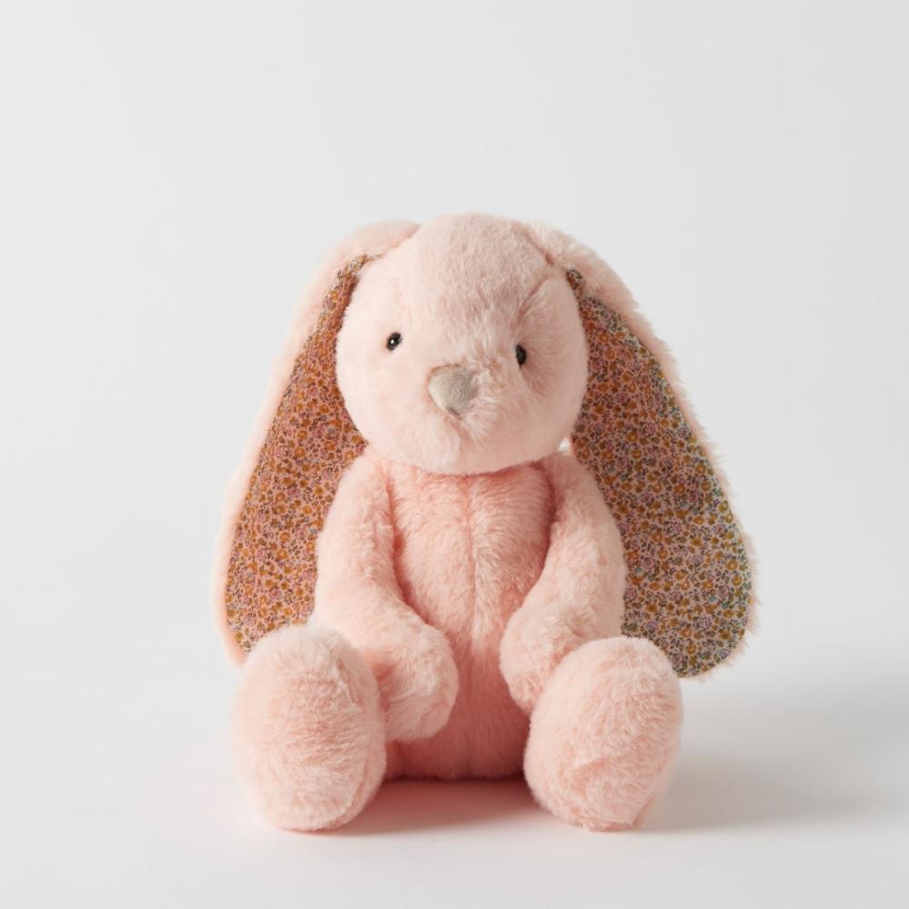 Pink plush bunny with floral ears on a white background