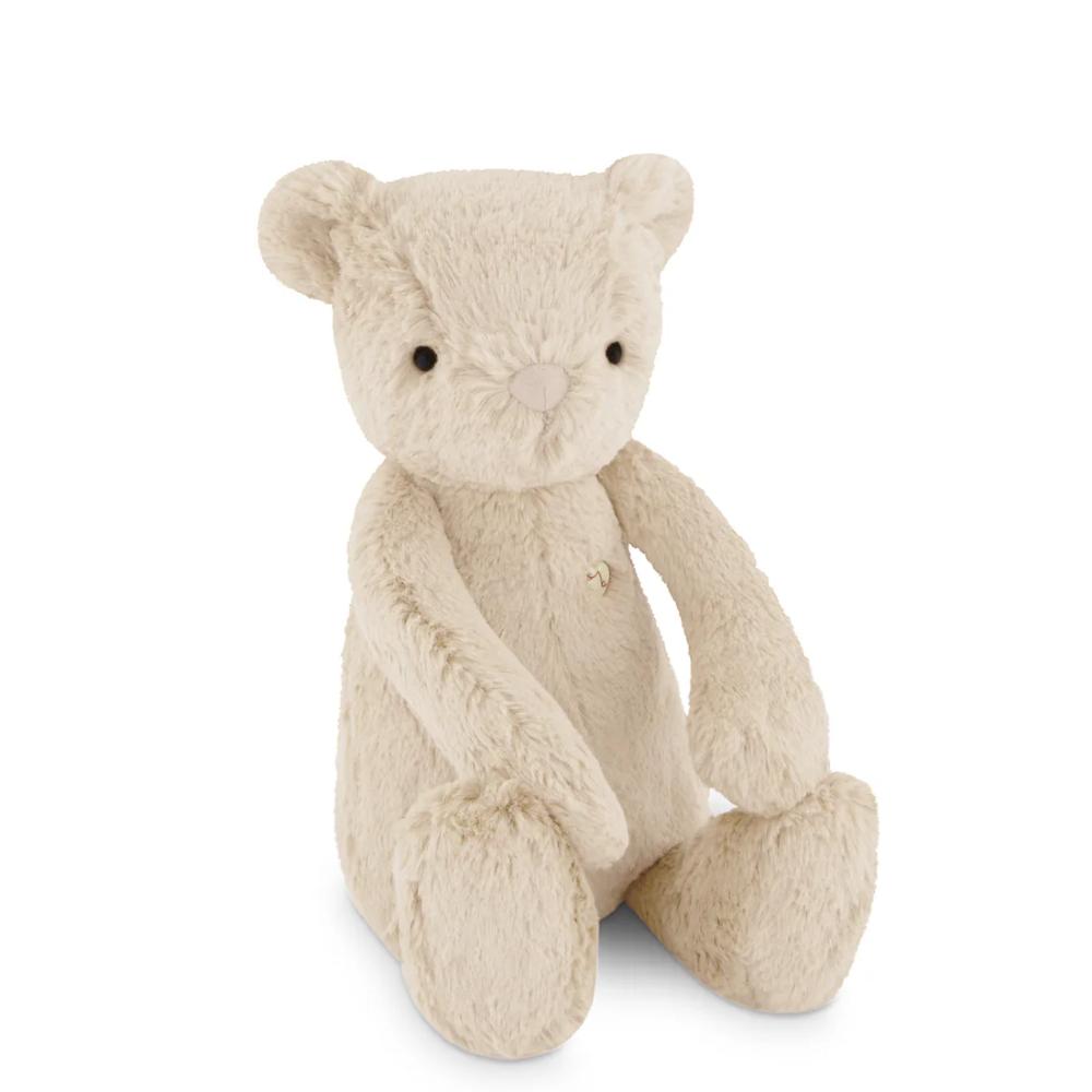 Beige Jamie Kay bear soft toy against white background.