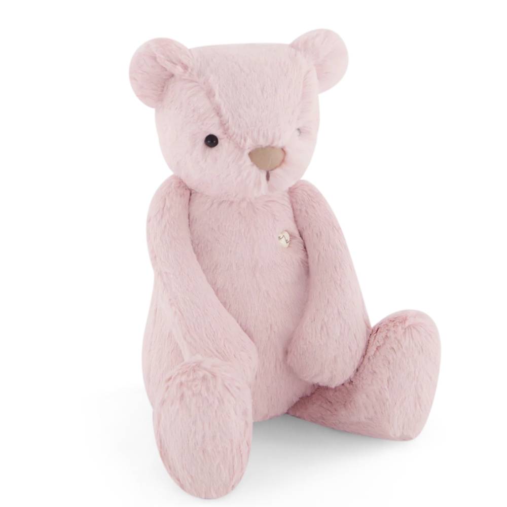 Pink Jamie Kay bear soft toy against white background.