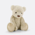 Beige plush Jamie Kay teddy bear sitting against white background.