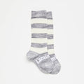Grey and white knee high socks on a white background