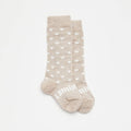 Beige spot pattern merino knee high socks on a white background