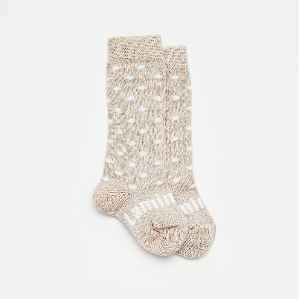 Beige spot pattern merino knee high socks on a white background