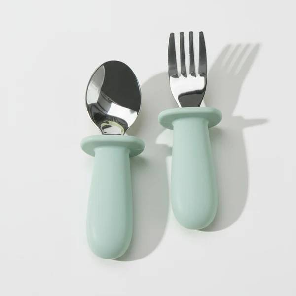 Blue Litill Lapsi fork and spoon against white background.