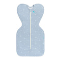 A blue fitted swaddle with an all over boats design, on a white background. 