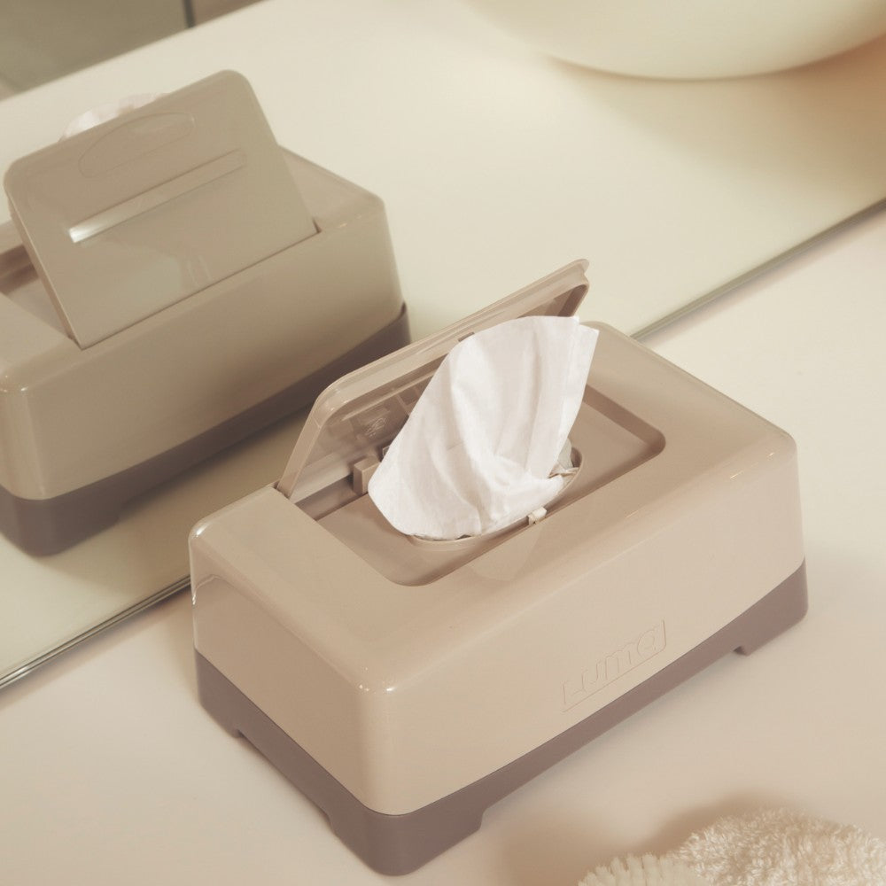 An open Almond LUMA Wipes Box sitting on a bathroom counter top. 