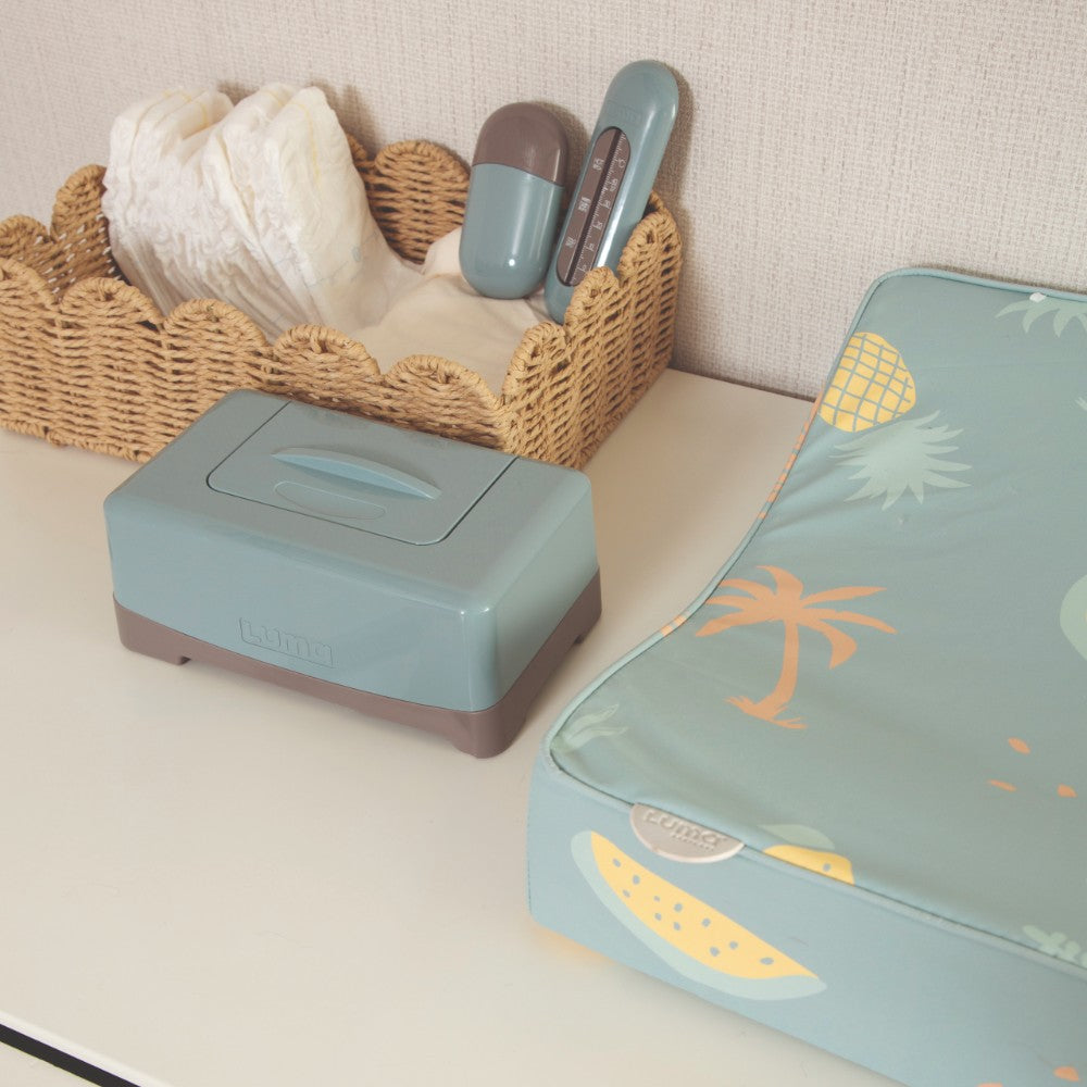 Ice Blue LUMA Wipes Box on a dressing station with other LUMA baby care items.
