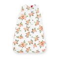 White and floral-patterned cotton muslin baby sleeping bag without sleeves on a white background