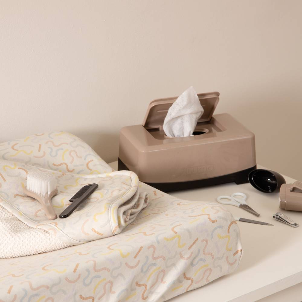 Desert Taupe LUMA Wipes Box on a dressing station with other LUMA baby care items.