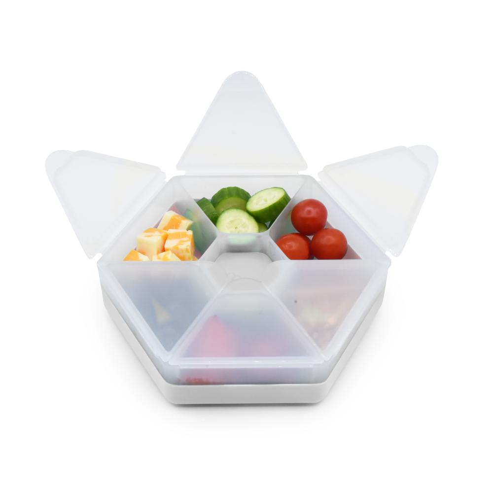 White compartmentalized snack container with fruits and vegetables on a white background