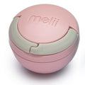 Pink dummy holder container with a green lid on a white background