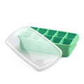 Green silicone baby food tray with a clear lid on a white background