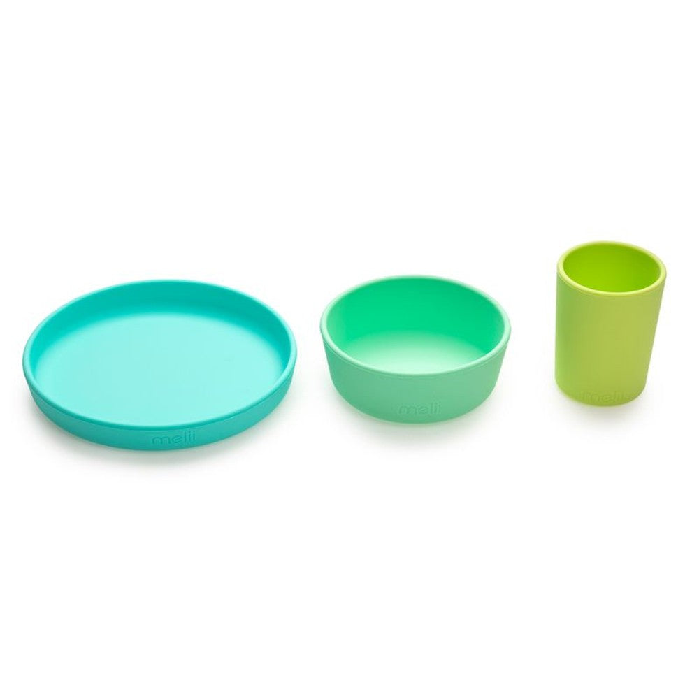 Set of three colorful kids silicone dishes on a white background