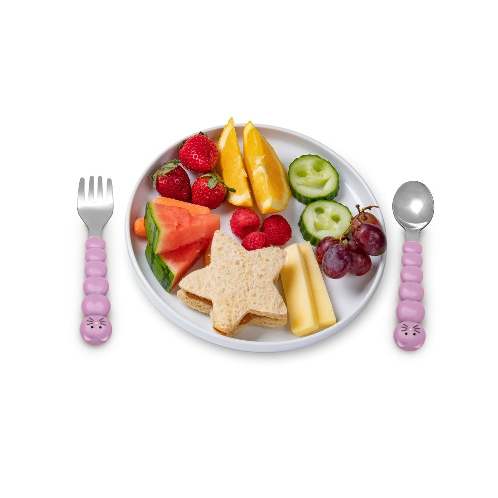 Children's plate with star-shaped sandwich, fruit, and cutlery on a white background